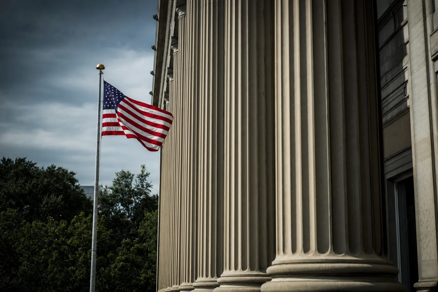 American flag beside neoclassical stone columns